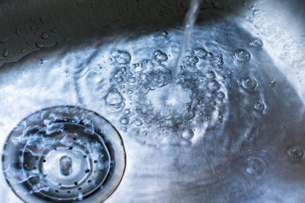 water pooling at the bottom of a kitchen sink