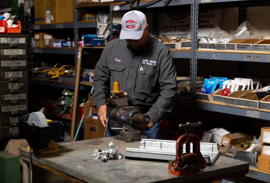 gotelli plumber assessing pipeline in workshop