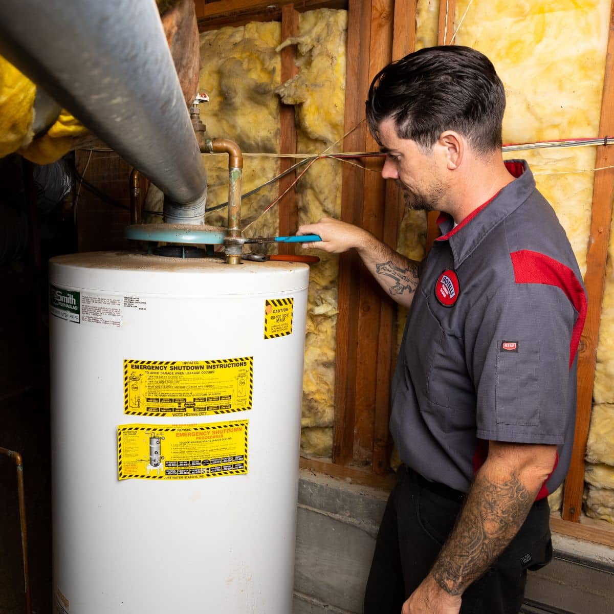 Gotelli employee standing next to a water heater