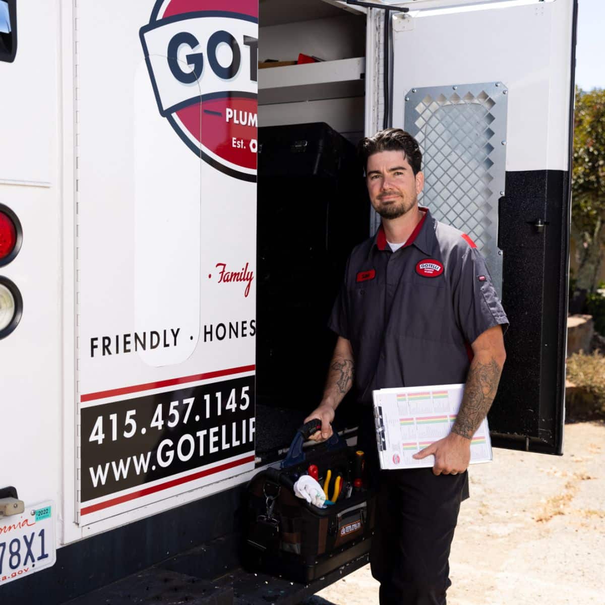 Gotelli technician standing behind a branded truck